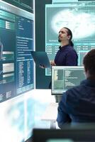 Governmental IT expert at work planning advanced cyber attacks on servers infrastructure to gather information, high tech spyware activity. Hacker breaking into accounts for cyberwarfare. photo