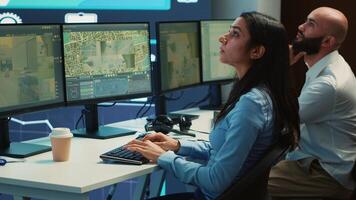Indian shipping agency employee gathering data on traffic via surveillance footage, helping delivery trucks with cargo for shipment. Operator uses gps coordinates for tracking orders. Camera A. photo