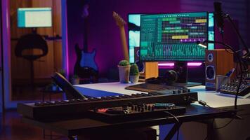 Creative space used at recording songs and tunes with daw software, various electronic equipment and tools for mix and master performance. Empty home studio with mixing panel and amplifier. Camera A. photo