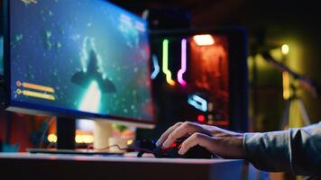 Close up shot of man using gaming rgb lit mouse to play entertaining videogame, flying spaceship through galaxy. Pro gamer using professional computer peripherals to enjoy science fiction game photo