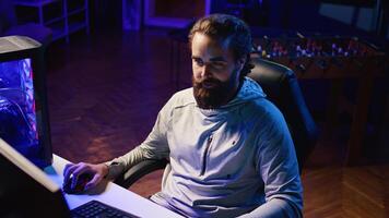 Professional gamer developing strategies for games, showcasing them to gaming community during livestream. Content creator testing different approaches to win videogame while streaming for fans photo