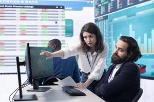 Company employees exchanging project details and big data to help in achieving business objectives, establishing budget and resources. Management team sharing information. photo