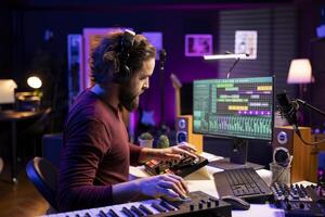 Sound engineer editing soundtracks and adjusting volume levels with daw software interface, working in music industry post production. Songwriter producer creating new songs with audio recordings. photo