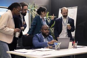 Sales analysts reviewing market trends and statistics in a conference room, meeting to create a new analysis for the new marketing strategy. Workers brainstorm innovative ideas. photo