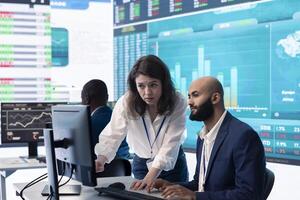 Team of investors analyzing profit amount and making decisions to fund another business project, examine big data on a huge display. Associates verifying efficiency and budget. photo
