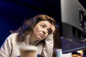 Worried system administrator stressed after finding many security vulnerabilities, scared of malware infections. Anxious IT staff member distressed by cyber attacks on computer systems photo