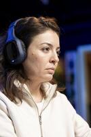 Cybersecurity expert listening music while looking for company security vulnerabilities, preventing malware infections. Technician with headphones on preventing cyber attacks on PC photo