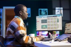 Person examining capital funds online for a new program at home, studying finances and accounting management on a software. Employee specialist doing remote work, startup analysis. photo