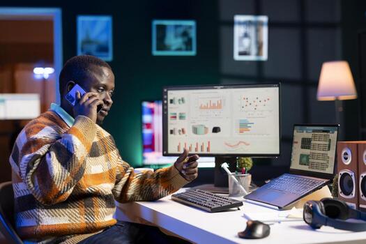 Male investor contacts his accountant at home desk to go over current budget balance, with objective to boost earnings via foreign investments. Man reviewing financial assets with consultant. photo