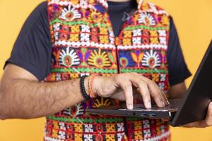 Close up shot of man writing on laptop keyboard, doing important work for company, isolated over studio background. Employee inputting data on notebook device, studio backdrop photo