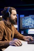 Freelancing developer listening audiobooks, building artificial intelligence neural networks computerized models. Tech support specialist enjoying podcasts while doing checkup on AI systems photo