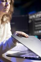 Cybersecurity expert using laptop to look for company security vulnerabilities and injected malware. Programmer installing fortified code on notebook device to prevent cyber attacks photo