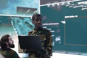 Commanding general of a division reviews warfare information within old mission files, special operation reconnaissance supporting field troops with crucial data. Briefing his military squad. photo