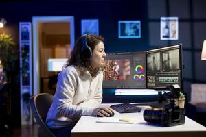 editor adds sound effects to filmed footage, working in post production creative studio. Videographer using headphones to test and improve audio quality, editing clips with professional software photo