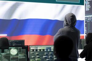 Russian hacker with a hood installing panic by misconception and manipulation, working in governmental cyber operations room. Impact of fake news and ideology propaganda in a hybrid war. photo
