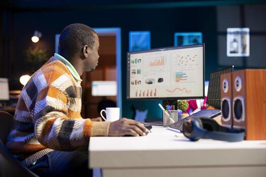 Young financial advisor examines monthly income and expenses to ensure a strategic plan on products and services. African american expert analyzing revenue balance, accounting analysis at home. photo