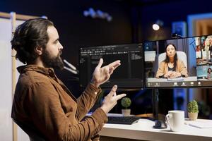 Programmer doing online tutoring, talking with students in videocall about ways to spot errors in code and do debugging. IT expert teaching trainees in teleconference how to fix coding mistakes photo