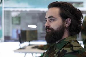 Brigadier general conducing anti terrorism operations in federal monitoring room, employing military systems to detect and track enemy aircraft or missiles. Secret service defense program. Close up. photo