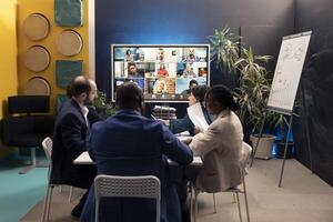 Executive board attending videocall online with shareholders, meeting to address enterprise issues and changes. Business associates making important decisions via telework conference. photo