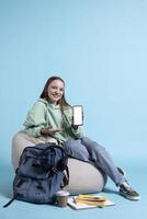 Smiling woman presenting mobile phone with isolated screen display, doing advertisement, studio background. Joyous person creating ad promotion with mockup smartphone device photo