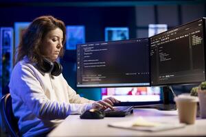 Freelancing professional working from home developing software in Java programming language using PC. Software technician in apartment writing lines of code on computer using keyboard photo