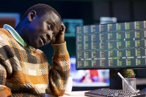 Tired financial advisor works on revenue balance with annual statistics, creating report for CEO under pressure before risking income in investments. Accountant evaluating legal insurance. photo