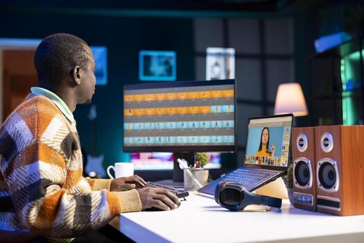 Skilled male designer using editing software on dual monitors in organized modern workspace, symbolizing the future of digital design and remote work. Digital art photo retouching.