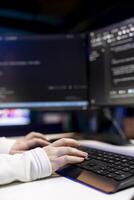 Woman typing on keyboard, implementing security measures to protect company systems and data. Close up shot of IT specialist writing, testing and debugging Java code for software applications, photo