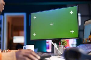 Black expert photo editor working remotely in a creative industry, using his skills and software tools on dual monitors to edit images with precision. Working on a freelance retouching project.