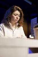 Sad system administrator pouting in frustration while doing software quality assurance, finding errors. Upset IT staff member inspecting coding on PC and seeing many issues photo