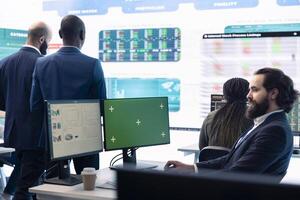 Sales manager examining success and efficiency metrics within the firm, reviews progress details next to isolated display on pc. Administrator evaluating statistics and team productivity. photo