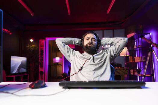 Gamer feeling angry after receiving game over screen in first person shooter. Player unable to believe his eyes after being defeated in videogame, losing all health, failing to win level photo