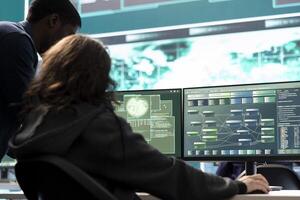 Professional IT expert working in a governmental security operations center, analyzing data on a big screen. Highlighting the importance of cyber security monitoring and threat analysis. photo