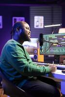 Professional singer composer creating a new song on paper, thinking about verses to blend together. Songwriter producing new music in home studio, working on soundtrack chorus and rhymes. photo