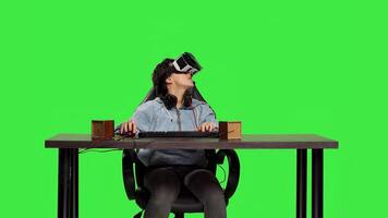 Disappointed player losing at games shooter competition with virtual reality headset, playing contest on computer against greenscreen. Sad frustrated woman being displeased. Camera B. photo
