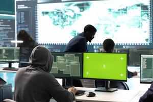 Governmental hackers using green screen in performing cyber security monitoring and threat detection. Examining network security and protection against cyber attacks, national intelligence. photo
