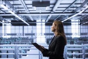 Employee with expertise in server maintenance, disaster recovery planning and security protocol enforcement working in data center to reduce downtime, ensuring business continuity photo