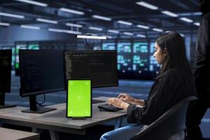 Admin in server hub uses isolated screen device to find firewall misconfigurations affecting performance. Woman checking systems bottlenecks leading to sluggish data transfer rates using mockup tablet photo