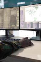 IT operator working on reconnaissance activity mission to gather important data, supporting deployed troops with battlefield information. Serviceman in military base monitoring room. Close up. photo