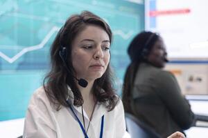 Business assistant calculating budget and costs to review the profit, working with big data in a organizational office space. Professional analyst examines finance infographics. photo