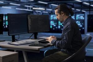 Admin typing on computer keyboard, doing maintenance in data center to extend equipment life span and avoid downtime. IT specialist monitoring blade servers for overheating problems photo
