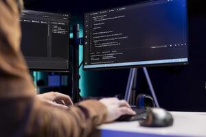 Teleworking cybersecurity administrator using computer to look for security vulnerabilities. IT technician typing on keyboard, installing safeguard code on PC to prevent cyber attacks, close up photo