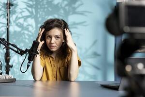 Woman feeling angry, sharing concerning story during social media , complaining in front of watchers. Upset media star talking with viewers, having mental breakdown in front of subscribers photo