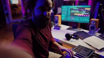 POV of musician playing on synthesizer for online piano lessons in his home studio. Singer songwriter filming vlog teaching about musical instruments, midi controller keyboard. Camera A. photo