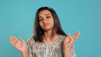 Lazy woman lacking interest for anything, feeling depressed, looking lifeless, isolated over studio background. Portrait of bored indian person suffering from tiredness, feeling exhausted, camera B photo