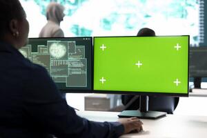 Group of professional hackers use mockup copy space screen in government operations center, high tech devices. Experts operating on big screen and surveillance for intelligence. photo