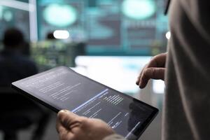 Governmental hackers analyzing big data for cyber threat detection, working at agency desks. Professional expert woman analyzes cyber intelligence and prevention of digital threats. photo