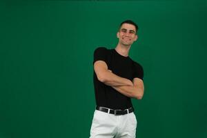 young handsome hicpanic man looking like a happy, proud and satisfied achiever smiling with arms crossed photo