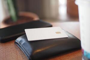 A minimalistic wallet and a card placed neatly on a table surface photo