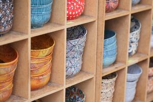 A Beautiful Array of Colorful, Handcrafted Bowls Artfully Displayed on a Rack photo